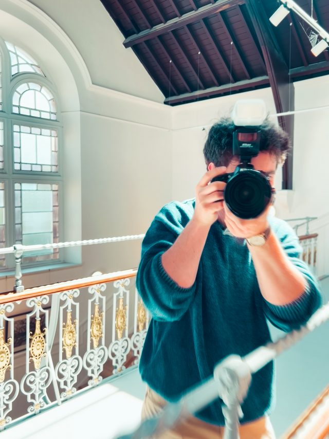 Content developer Lewis MacFarlane holding up a camera to take a picture.